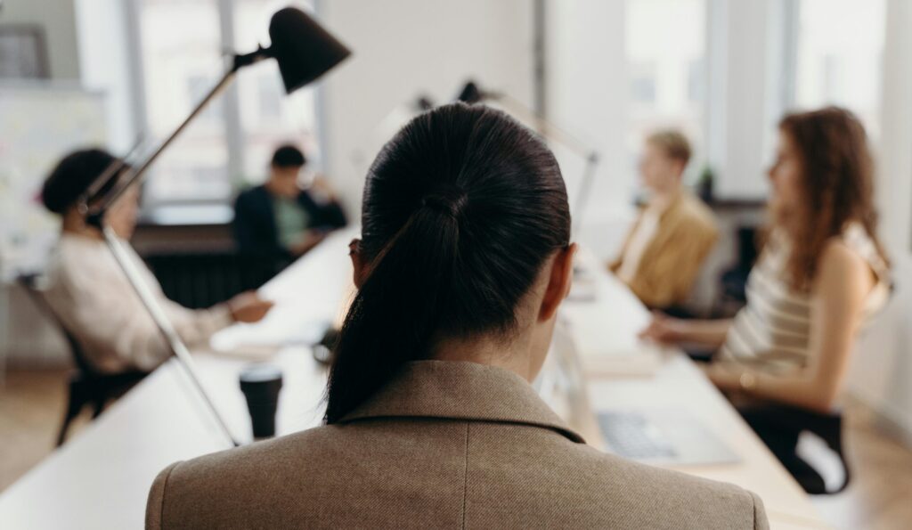 Diverse professionals collaborating in a modern office space, focused on teamwork and project management.