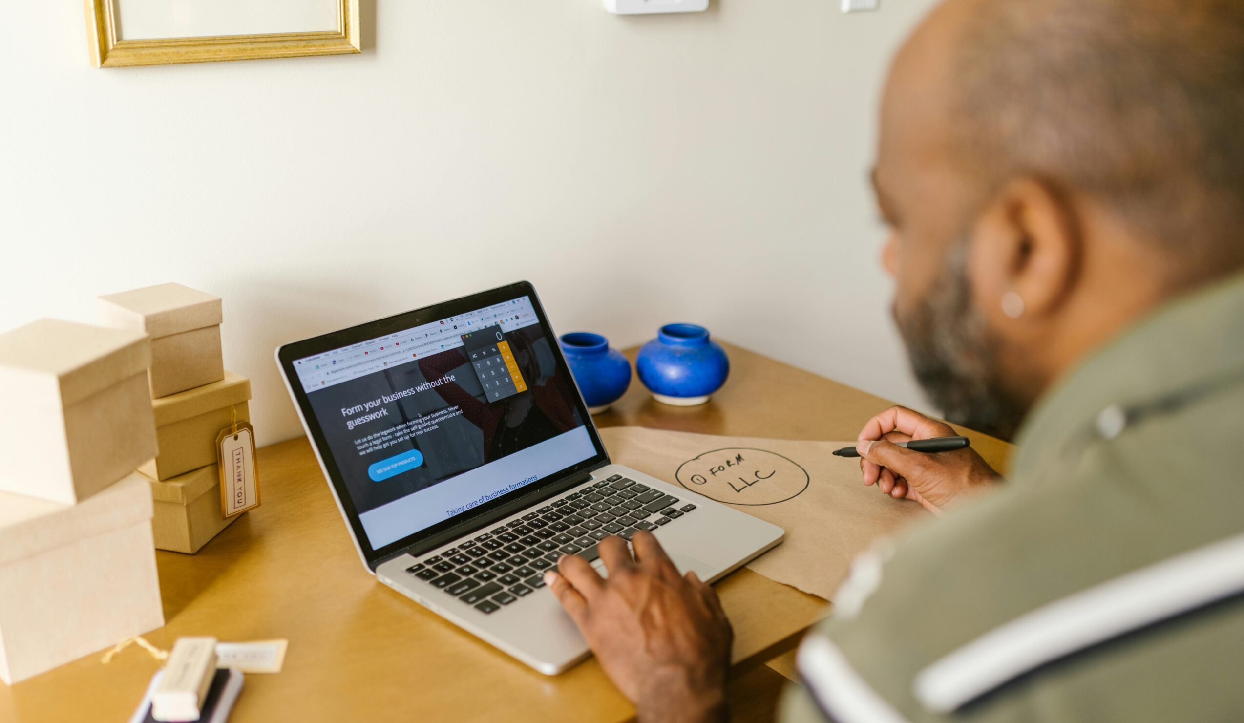 Entrepreneur at a desk using a laptop for business planning. Ideal for tech and startup themes.